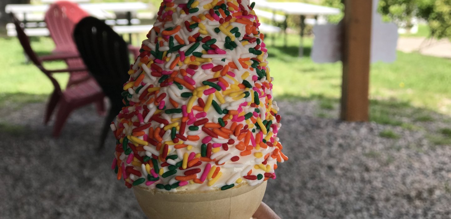 vanilla ice cream cone with rainbow sprinkles